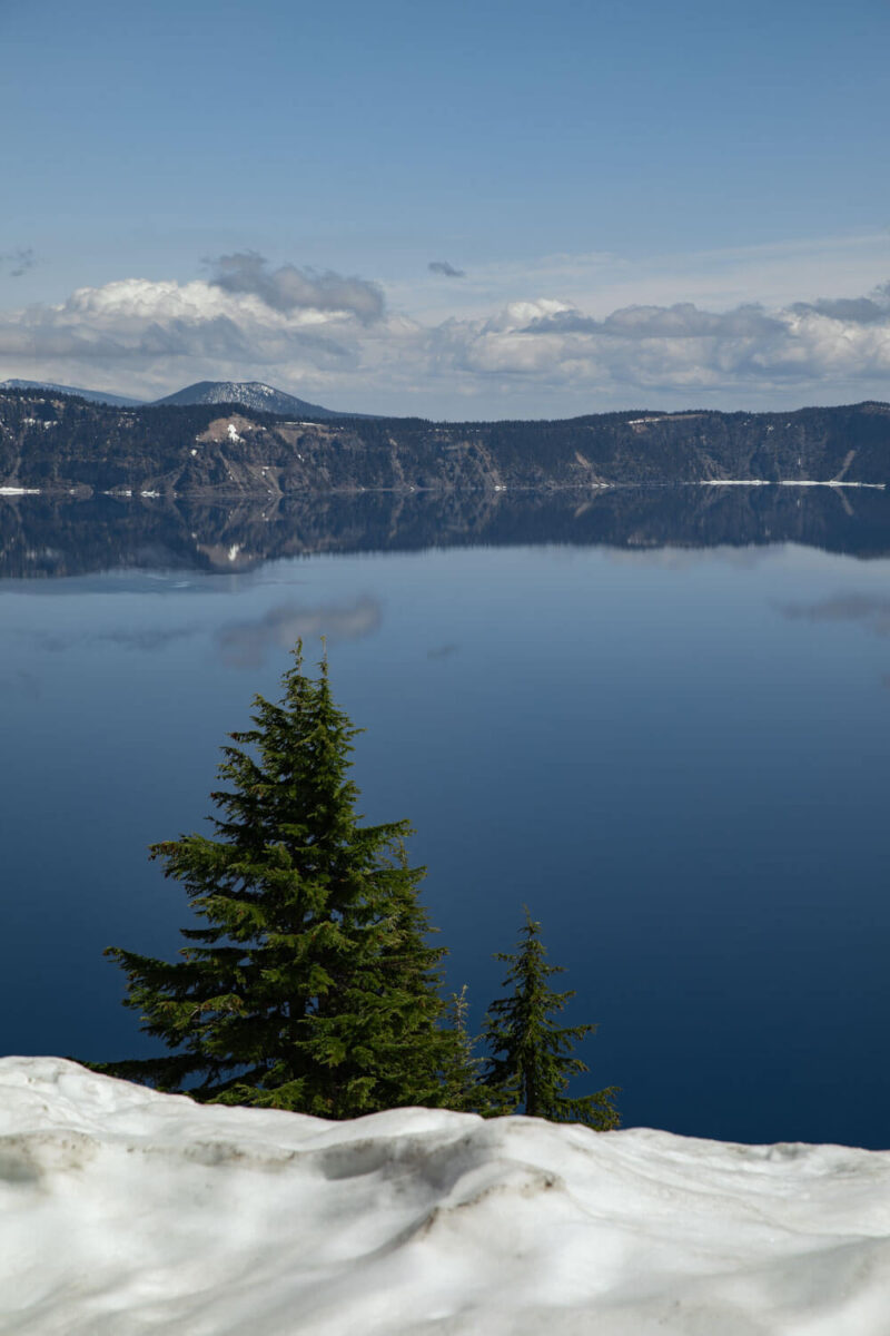 crater lake during the daytime reflecting the blue sky