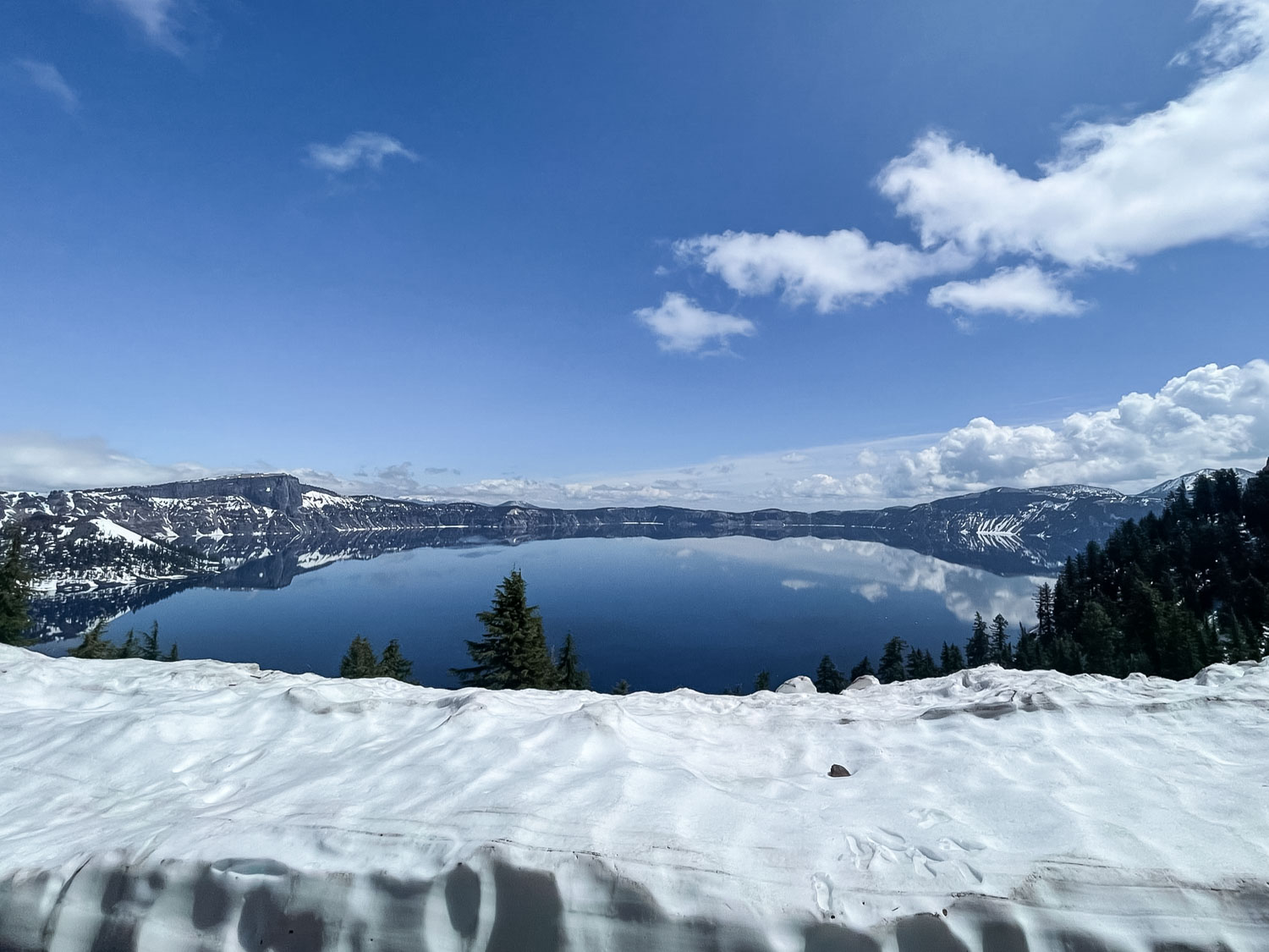 crater lake with snow in may