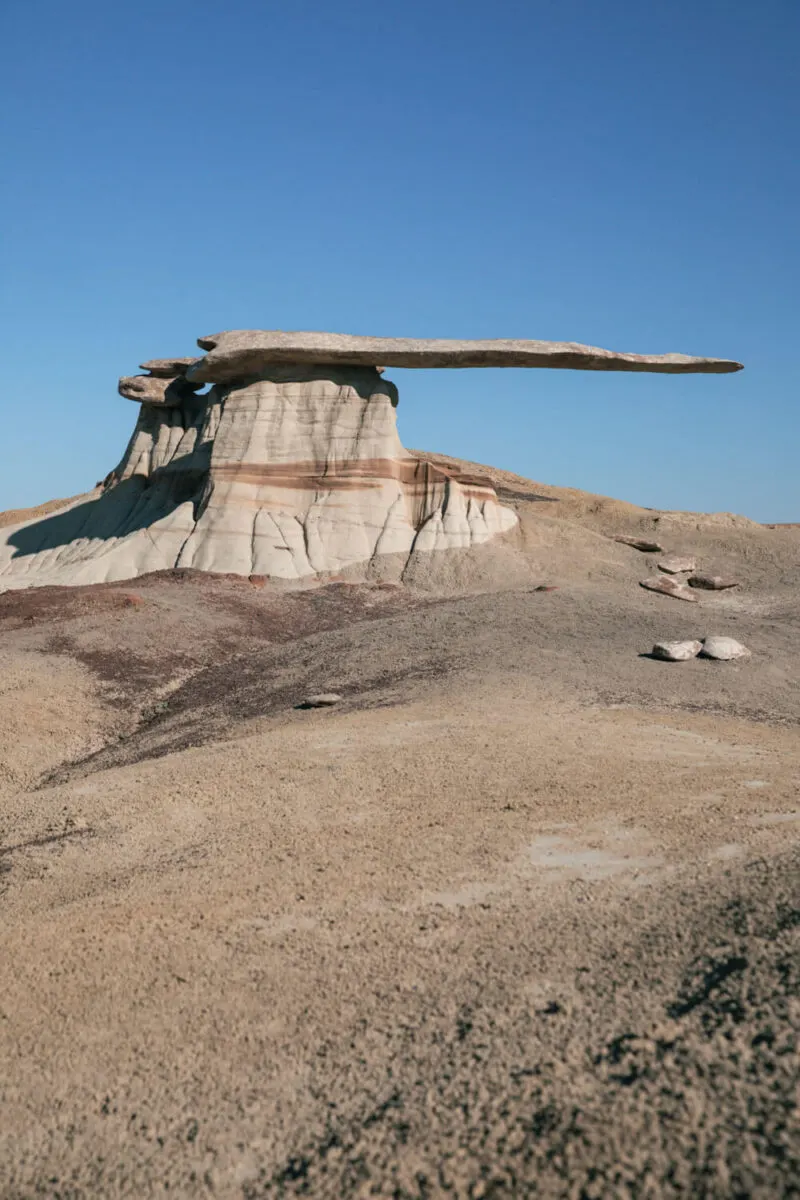 king of wings new mexico is a winged hoodoo with a massive stone balanced on a clay pedestal