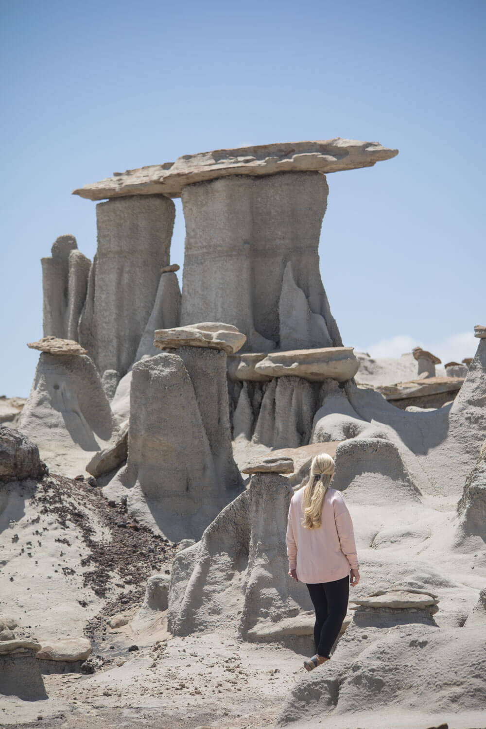 woman in front of three kings in valley of dreams east new mexico near the bisti badlands