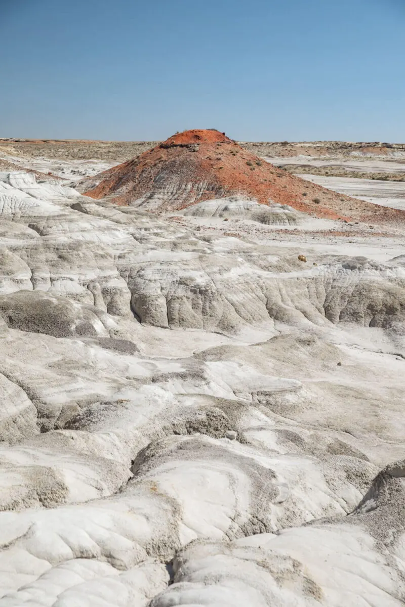 white rocks and hill of orange dirt in valley of dreams